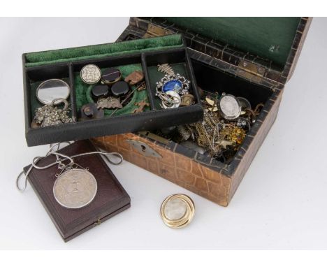 A miscellaneous collection of costume jewels, including a marcasite flower brooch, a pair of enamel circular buttons, a 1977 