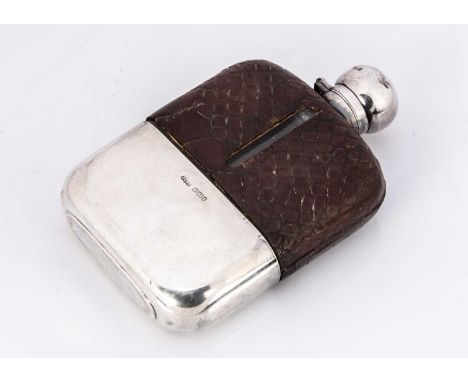 An Edwardian glass and silver hipflask, 15cm, with brown leather upper, some damages, slide off silver cup to lower, fits wel