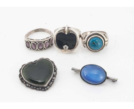 A collection of silver jewels, including a Finnish modernist ring in the form of an apple, two brooches and two rings