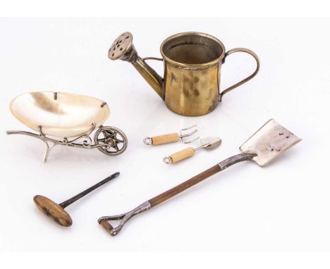 Two miniature silver mounted dolls' house gardening items, including a shovel, 12.8cm long, and a wheel barrow with shell, to