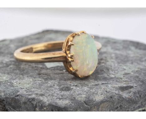 An Edwardian 18ct yellow gold opal dress ring,  the cabachon oval in claw setting, on a plain tapering shank, ring size M, Bi