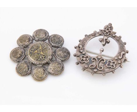 A Celtic white metal open work plaid brooch, 4.2 cm by 3.5 cm together with a Celtic silver plated circular example 4 cm (2)