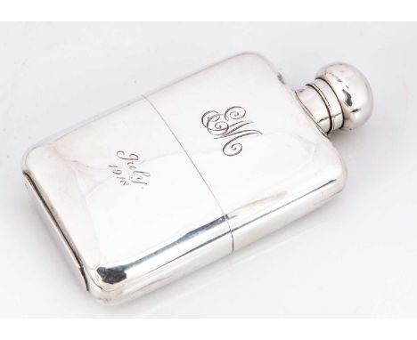 A George V silver hipflask by GN GN, 16cm and 10.75 ozt, with engraved EM and July 1918, removeable lower cup, some dents and