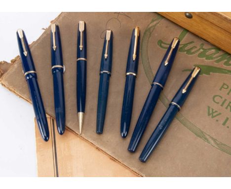 Six  blue Parker fountain pens, along with a blue Parker retractable pencil, all with gold coloured clip and mounts, three wi