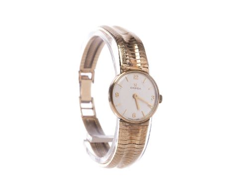 LADY'S OMEGA NINE CARAT GOLD MANUAL WIND WRIST WATCHthe round dial with applied Arabic numerals and baton hour markers, 18mm 