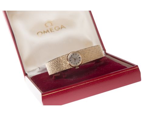 LADY'S OMEGA NINE CARAT GOLD MANUAL WIND WRIST WATCHthe round white dial with applied baton hour markers, 16mm case, on a nin
