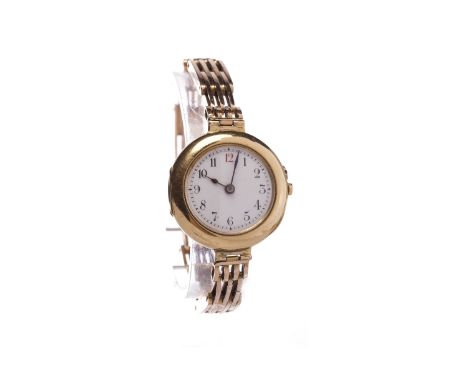 LADY'S EARLY TWENTIETH CENTURY EIGHTEEN CARAT GOLD MANUAL WIND WRIST WATCHthe round white dial with Arabic numerals in black,