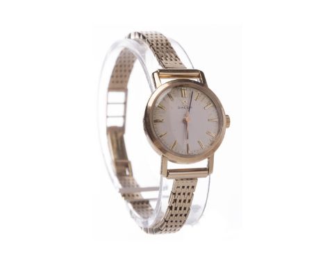 LADY'S OMEGA NINE CARAT GOLD MANUAL WIND WRIST WATCHthe round buff dial with applied gold coloured baton hour markers, outer 