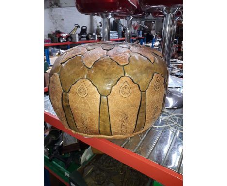 A retro tan leather pouffe. 