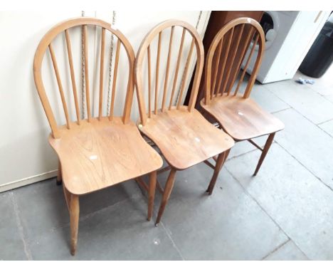 A set of three Ercol light beech and elm spindle back chairs with shaped seats. 