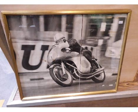 An Isle Of Man TT photographic print signed by John Surtees 50cm x 40cm and another motorcycle print. 