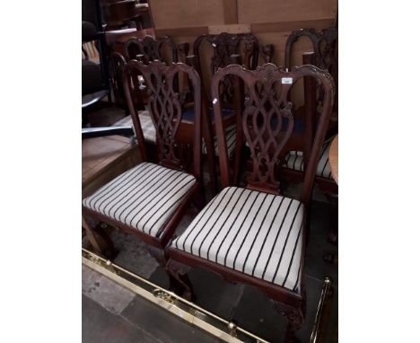 A set of seven reproduction Chippendale style mahogany dining chairs. 