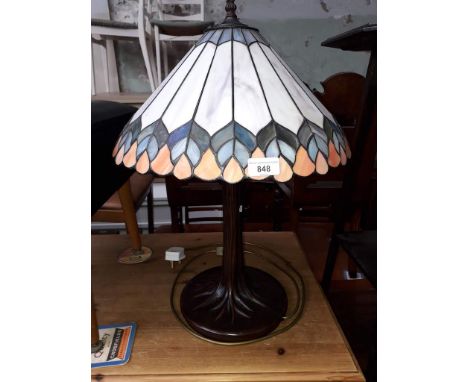 A reproduction Tiffany style table lamp with tree effect stem, leaded glass shade, height 57cm.Condition: no signs of any dam