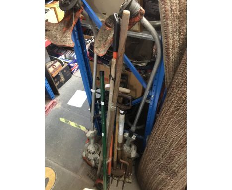 Garden tools including a bundle of spades, forks, rakes and hoes, a manual lawn spiker, and s Stilhl strimmers (AS FOUND) 