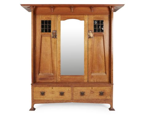 HARRIS LEBUS, LONDON  ARTS & CRAFTS OAK TWO-PIECE BEDROOM SUITE, CIRCA 1900   comprising a WARDROBE, with broad projecting co