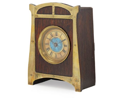 AUSTRIAN SCHOOL  SECESSIONIST STYLE OAK MANTEL CLOCK, EARLY 20TH CENTURY   the shaped rectangular front mounted with brass, e