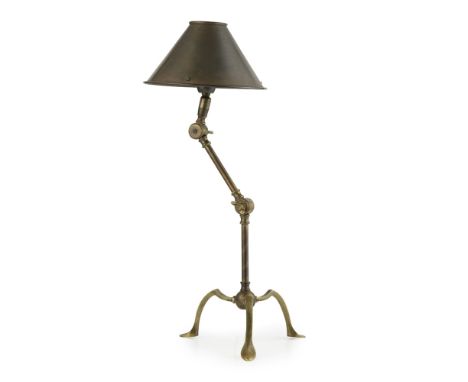 MANNER OF W.A.S. BENSON  BRASS TABLE LAMP, EARLY 20TH CENTURY   with a conical shade over a sectional column, raised on a tri