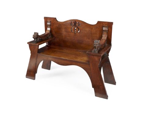 WYLIE & LOCHHEAD, GLASGOW  OAK HALL BENCH, CIRCA 1900   the pierced back enclosed by open arms with carved lion surmounts, ra