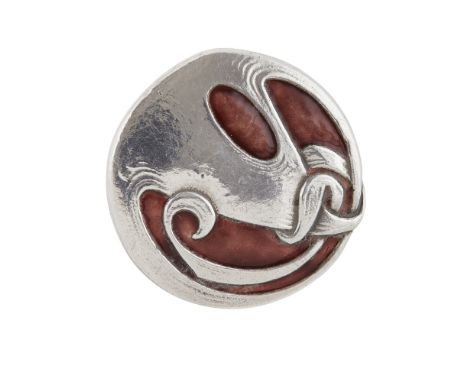 ARCHIBALD KNOX FOR LIBERTY & CO., LONDON  SILVER AND ENAMEL BROOCH, 1917   of circular form cast with stylised whiplash folia