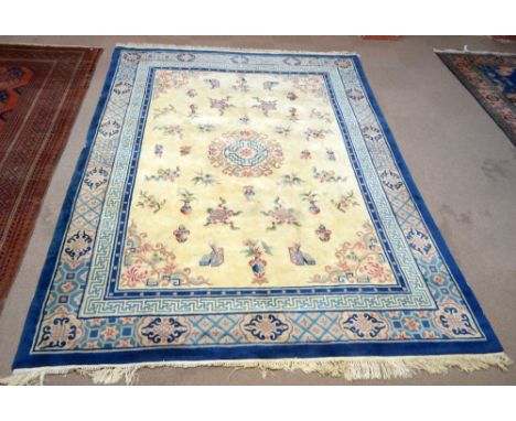 A large Chinese superwash carpet with stylised foliate decoration to cream and blue grounds, approx 365 x 274cm.  CONDITION R