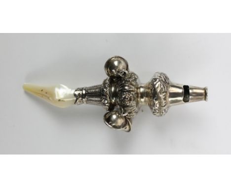 A Victorian hallmarked silver mother of pearl handled rattle surmounted with a whistle above knopped foliate and floral embos