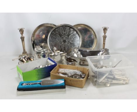 A quantity of electroplated items to include circular trays, a rectangular footed dish, a teapot, a sauce boat with cover, a 