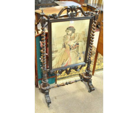 A Victorian rosewood fire screen with central woolwork panel in elaborate detailed frame, height 108cm, width 65cm.