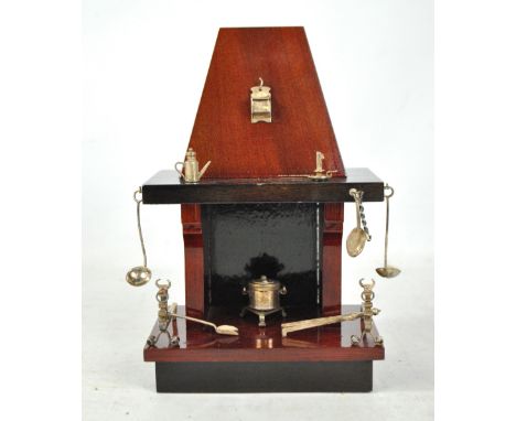 A set of Italian silver fireplace miniature items to include a stove, a chamber stick, a shovel and fire tongs, silver standa