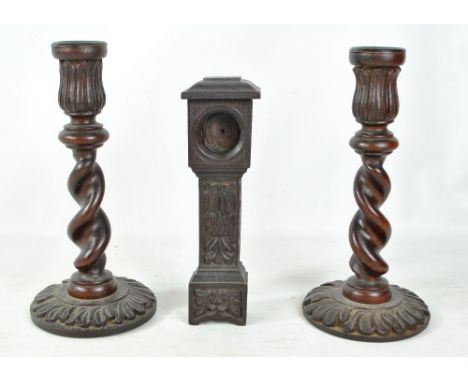 A pair of Macclesfield School of Carving barleytwist stem and floral detailed candlesticks, height 28.5cm, and a pocket watch