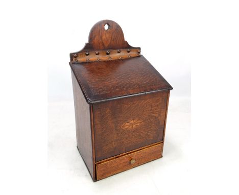 A late George III oak mahogany crossbanded and inlaid candle box, the studded leather hinge above oval inlaid front panel wit