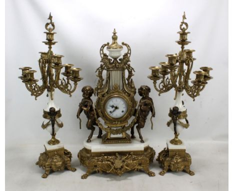 A gilt metal mounted three piece mantel clock garniture, the clock with circular dial stamped 'Imperial' and flanked by bronz