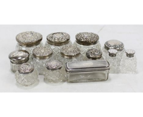 A group of variously hallmarked silver topped dressing table jars to include two globular shaped pairs, one by Adie &amp; Lov