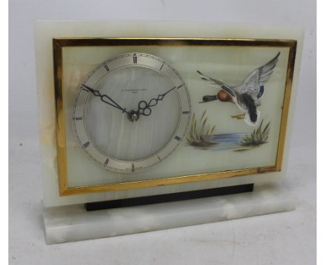 An Art Deco onyx mantel clock, the silvered chapter ring set with Roman numerals and signed 'W. Greenwood &amp; Sons Leeds' w