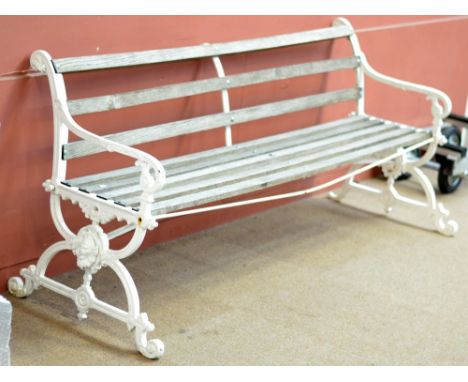 A white painted cast iron garden bench with later wooden slats, width approx 180cm. CONDITION REPORT: As stated the slats app