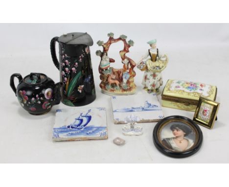 Two 18th century blue and white tiles, a Jackfield type enamel painted lidded jug, a similarly decorated small teapot, a Staf