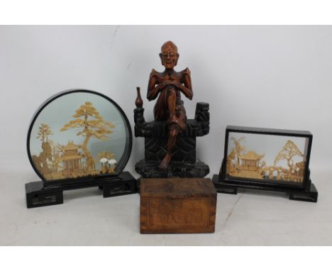 A Japanese wooden carving depicting a seated skeletal man on carved base, height 33cm, also with two cork carvings and an Eas