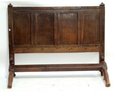 An oak bed, the headboard constructed from the panel from an 18th century coffer, complete with irons, width 141cm. CONDITION