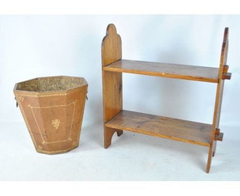 An early to mid-20th century gilt tooled leather waste paper basket with twin brass lion head mask handles, height 30cm, and 