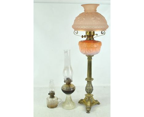 A Victorian brass oil lamp with opaque graduated pink glass reservoir and frosted peach shade (af), on tripartite base with p