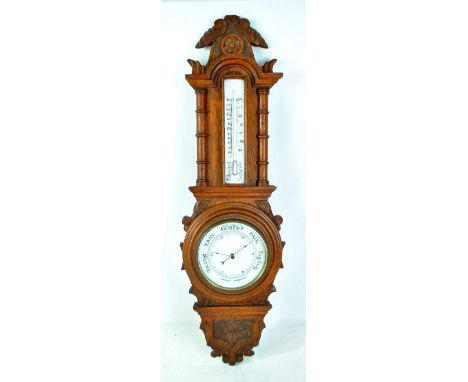 A thermometer and barometer combination in carved oak case, length 84cm. CONDITION REPORT: Not currently functioning, crack t