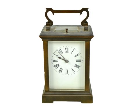 A late 19th century French brass repeating carriage clock, the white enamel dial set with Roman numerals and back plate no.62
