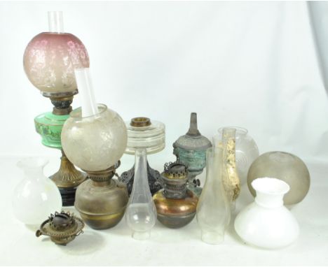 A group of lamps and lamp fittings including a floral painted Victorian lamp, a floral etched globular shade, a similar shade