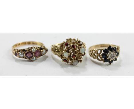 Three dress rings comprising a 15ct yellow gold seed pearl and amethyst coloured stones set example, size P, a 9ct gold plast