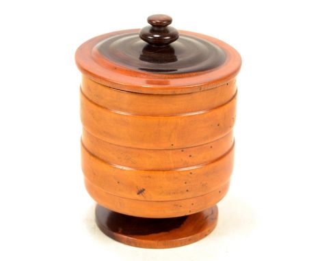A good 19th century turned lignum vitae cylindrical box and cover, the lid with knop finial above main body with two raised b