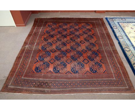 A red ground carpet with geometric decoration, approx 369 x 312cm. CONDITION REPORT: Heavy worn in areas, discolouration in p