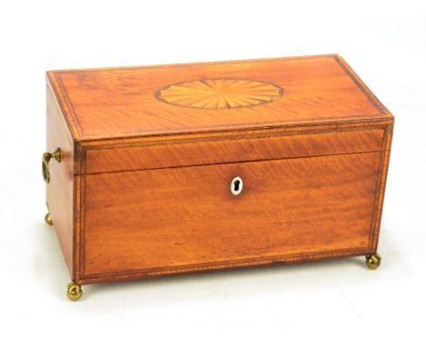 A satinwood crossbanded tea caddy of George III design, the hinged lid enclosing one large lidded compartment flanked by bras