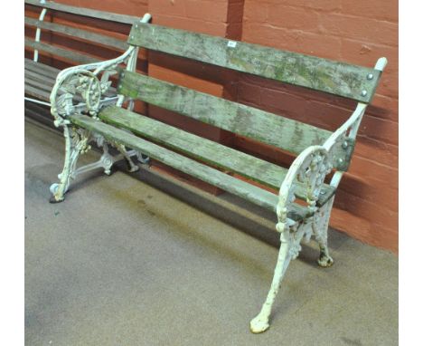 A white painted cast iron garden bench, width approx 122cm.