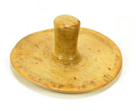 A 19th century sycamore cheese press with slightly domed circular main panel and integral turned handle, diameter approx 20.5