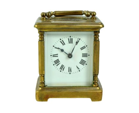A small sized carriage clock, the circular dial set with Roman numerals, height excluding handle 9.5cm. CONDITION REPORT: Has