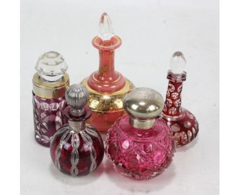 Five various scent bottles to include a hallmarked silver mounted cranberry hobnail cut glass globular example, The Original 